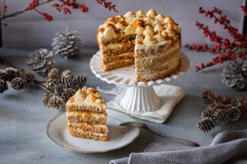 Salzkaramell-Torte mit Mascarponecreme, 1 Stück auf einem Teller, hinten die Torte