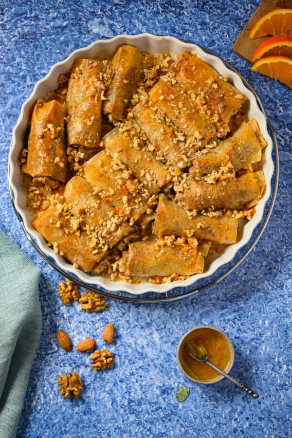 Selbstgemachte Baklava in einer weißen Tarteform auf blauem Untergrund, von oben